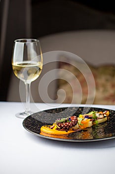 Tentacles of an octopus on a mango puree, restaurant serving of a dish
