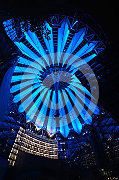 Tented glass roof dome with skyscrapers of the Sony Center at night with illumination