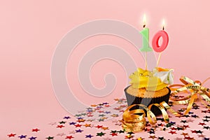 Tenth birthday cupcake with candle and sprinkles