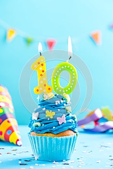 Tenth 10th birthday cupcake with candle. Card mockup. photo
