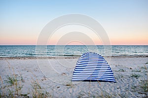 Tents on beach of white sandunder blue sky