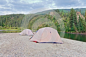 Tents at river in remote Yukon taiga wilderness