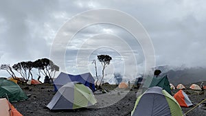 Tents are in the Shira Cave Camp. Foggy mountain landscape. Climbing Kilimanjaro, Africa