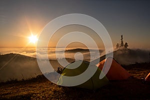 Tents at sunrise under clouds