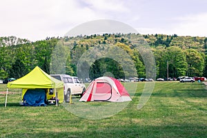 Tents on Woods Mountain Grassy Landscape on Camping site at a Music Festival