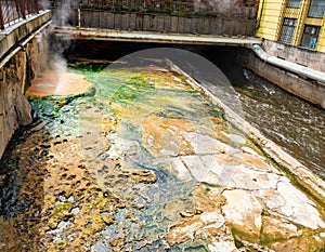 Tepla river under the bridge Vridelni lavka. Water full of sediments