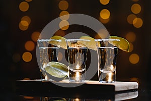 Tequila with lime on a dark background