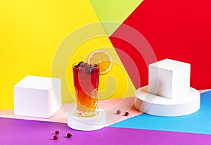 Tequila Madras cocktail with tequila, orange, cranberry juice and ice. Modern style still life on bright multicolored background