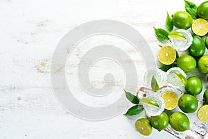 Tequila with salt and lime on a white wooden background. Fruits. Top view.