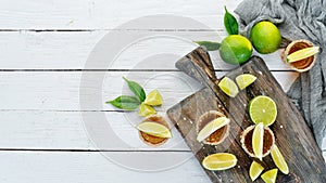 Tequila with salt and lime on a white wooden background. Top view.