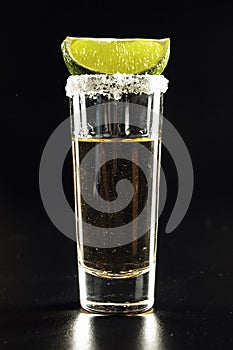 Tequila shot on black background. Close up.