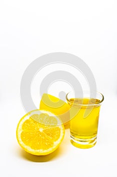 Tequila shot with lemon on a white isolated background