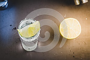 Tequila shot with lime fruit/Tequila shot with lime fruit on a bar. Top view