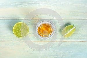 Tequila shot with lime slices, a Mexican drink with a salt rim, overhead shot