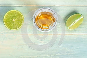 Tequila shot with limes, Mexican liquor with a salted rim, shot from the top