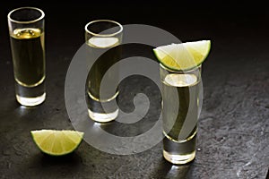 Tequila shot, mexican Alcoholic strong drinks and pieces of lime with salt in mexico