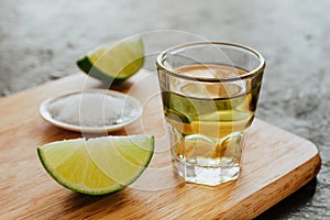 Tequila shot, mexican Alcoholic strong drinks and pieces of lime with salt in mexico