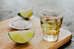 Tequila shot, mexican Alcoholic strong drinks and pieces of lime with salt in mexico