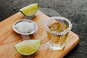 Tequila shot, mexican Alcoholic strong drinks and pieces of lime with salt in mexico