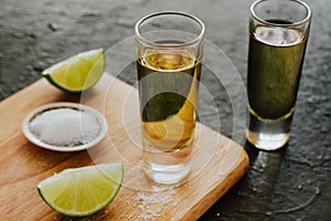 Tequila shot, mexican Alcoholic strong drinks and pieces of lime with salt in mexico photo