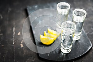Tequila shots on the dark rustic background