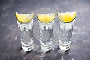 Tequila shots on the dark rustic background