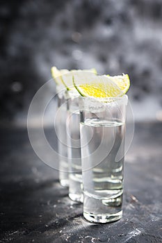 Tequila shots on the dark rustic background