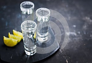 Tequila shots on the dark rustic background