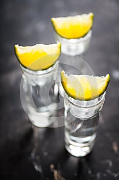 Tequila shots on the dark rustic background