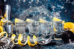 Tequila shots with lemon slices and cocktail details. Alcoholic drinks in shot glasses served in pub or bar