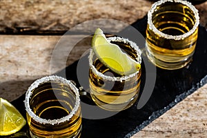 Tequila shots with salt and lime Mexican national drink. Golden tequila shots. Mexican national drink. top view