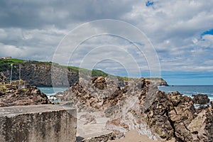 Terceira, Azores PORTUGAL - 1 August 2020 - Wall and volcanic rocks next to the natural sea pools of Quatro Ribeiras photo