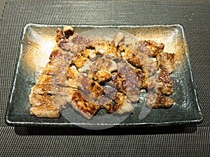 Teriyaki Chicken and Grilled Pork in black dish