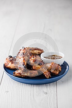 Teriyaki chicken wings with sauce on white table top