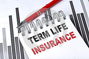 TERM LIFE INSURANCE text written on notebook with pen on chart