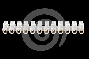 Terminal block on 12 contacts for connection of electric wires. Set of white plastic electrical terminal block, isolated on black