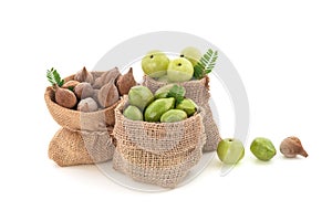 Terminalia bellirica, Terminalia chebula and Phyllanthus emblica fruits in sack isolated on white background with clipping path