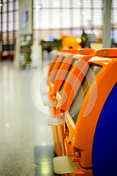 Terminals for self check-in standing in row at airport.