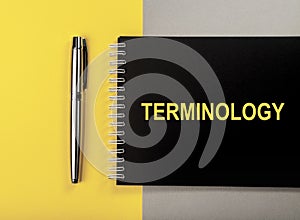 Terminology word on black notebook, top view photo