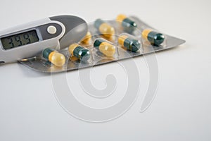 A termometr with high temperature and antibiotics pills.