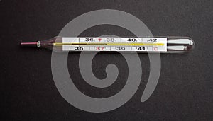 A termometr with high temperature on a black background with