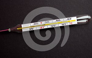 A termometr with high temperature on a black background with