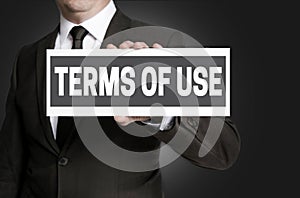 Terms of Use sign is held by businessman