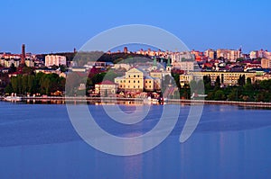 High perspective view of old part of city with lake, embankment,Taras Shevchenko Park and ancient building during spring sunset