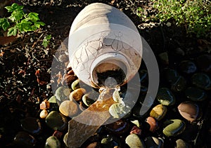 Terra Cotta Jug with water pouring in sunshine