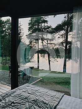 Terrace with chairs at country side house, waterfront vacation hotel.