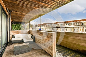 a terrace with a couch and a wooden deck