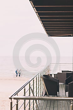 Terrace and cyclists on the beach