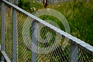 Terrace fencing, railings of metal pipes filled with steel cables cable mesh. fencing wire stainless steel fence. wooden floor, da
