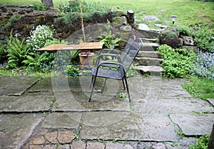 Terrace with garden furniture during heavy rain.